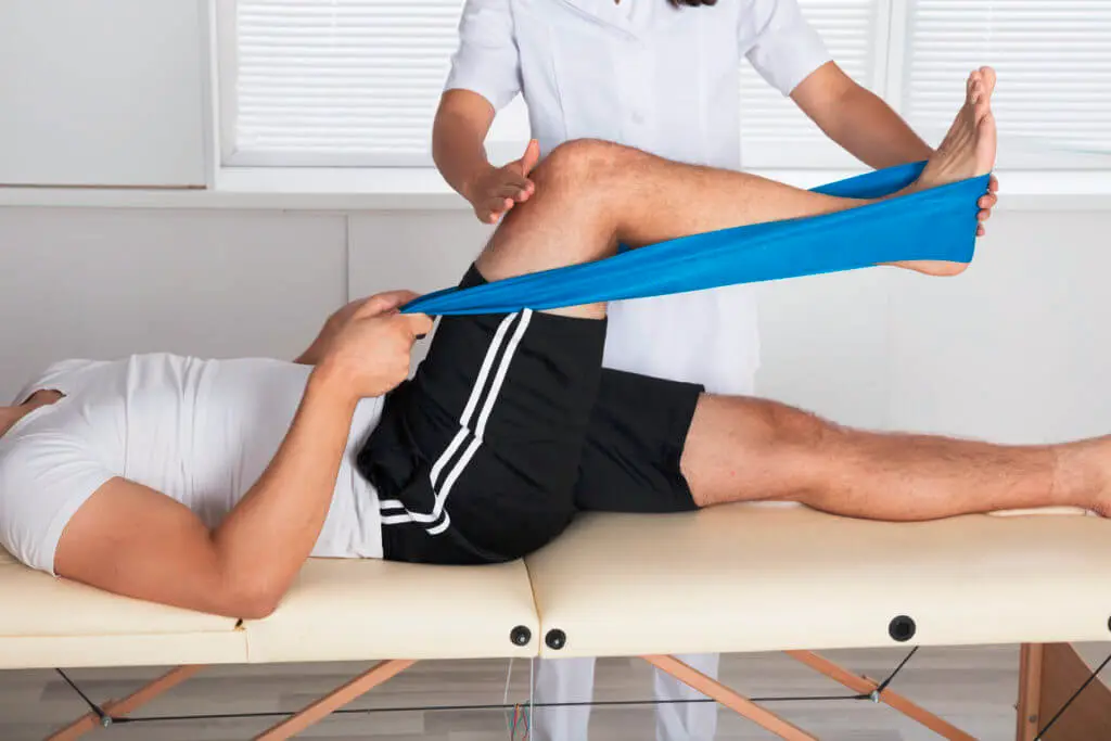 Therapist guiding a patient through a resistance band exercise